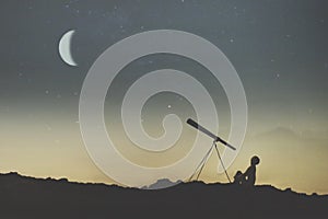 Silhouette of a boy observing the sky on a starry night with his telescope