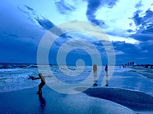 Silhouette of boy playing at a beach