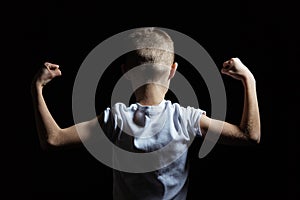Silhouette of a Boy Showing Arm Muscles Strength