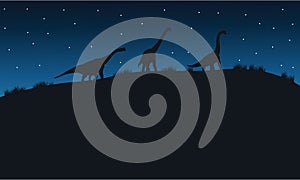 Silhouette of brachiosaurus with star