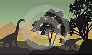Silhouette of brachiosaurus and T-Rex in hills
