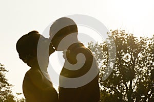 Silhouette of bride and groom kissing