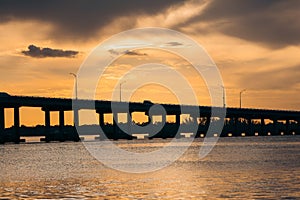 Silhouette of bridge over Caloosahatchee river during sunset