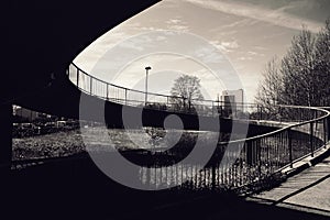 silhouette bridge over river against sky