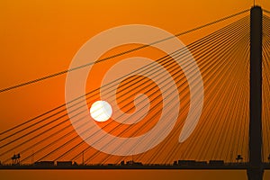 Silhouette of a bridge under setting sun