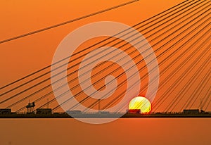 Silhouette of a bridge under setting sun