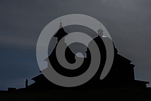 Silhouette of brown wooden old chapel on Radhost hill in Beskydy mountains