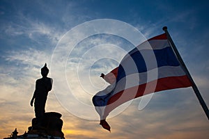 Silhouette of Buddha statue and Thailand flag at Phutthamonthon,