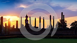 Silhouette of Buddha statue and Wat Mahathat Temple