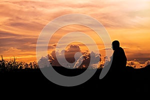 Silhouette - The Buddhist Monk Meditation and clouds evening sky