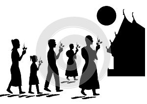 Silhouette of Buddhists walk with a burning candle