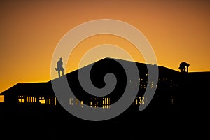 Silhouette of builders during sunset