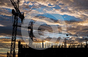 Silhouette building construction site with sunset sky background