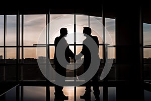 Silhouette of business handshake, teamwork concept.