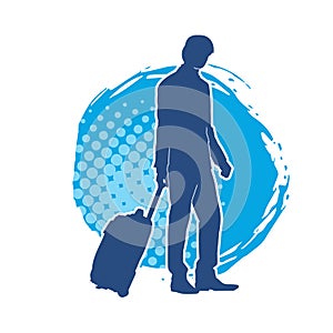 Silhouette of a business man in business trip pulling a luggage travel bag