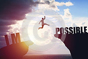 Silhouette of business man jump to success text over a beautiful view mountain background