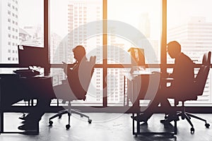 Silhouette business man in office working at desk