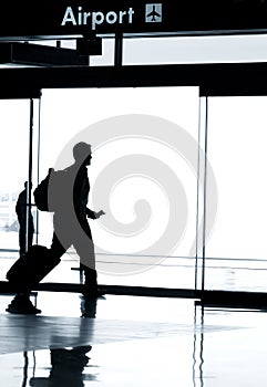 Silhouette of business man walking in airport