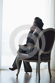 Silhouette of business woman talking mobile phone