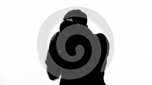 Silhouette of businessman boxing invisible opponent, protecting his business