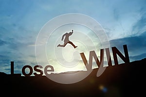 Silhouette of businessman glowing jump Lose to Win. success concept