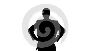 Silhouette of businessman holding hands on his hip, seriousness of intentions