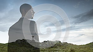 Silhouette of businessman with landscapes on background, double exposure.