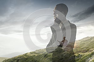 Silhouette of businessman with landscapes on background, double exposure.