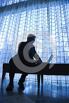 Silhouette of businessman and laptop.