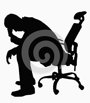 Silhouette of businessman sitting with hand on his head.