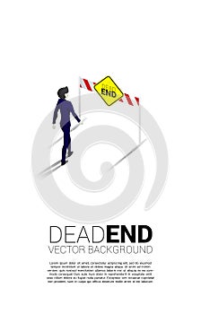 Silhouette businessman walking to dead end signage .