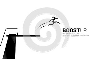 Silhouette of businesswoman jump higher with springboard.