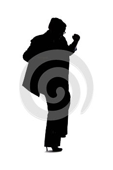 Silhouette of a Businesswoman Kicking Something