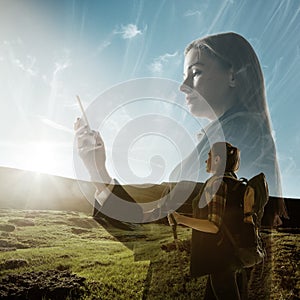 Silhouette of businesswoman with landscapes on background, double exposure.