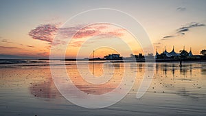 Silhouette of Butlins with the reflection on Minehead beach on the sunset