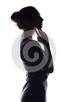 Silhouette of a calm young woman on a white isolated background, figure of slim pensive girl