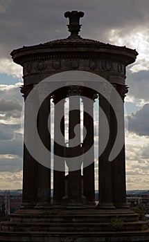 Silhouette of Calton hill monumner with a cloudy evening sky in