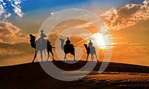 Silhouette camel caravan at the Thar desert Jaisalmer, Rajasthan India at sunset