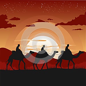 Silhouette of camel caravan traveling in desert at sunset