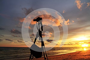 Silhouette of Camera on sunset background colourful sky.