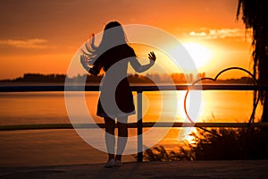 Silhouette of carefree woman in sunset on beach. vacation vitality healthy concept