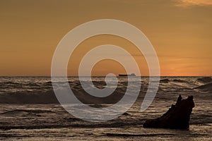 Silhouette of cargo ship on the horizon