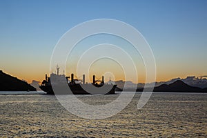 Silhouette of a cargo ship leaving the port of Santos