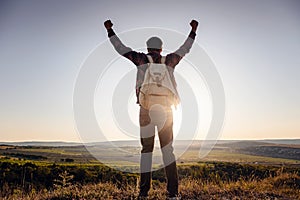 Silhouette of a champion on mountain peak. Active life concept