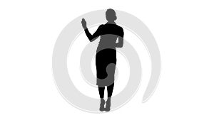 Silhouette Charming smiling energetic woman in formal clothes talking to camera and pointing to the sides.