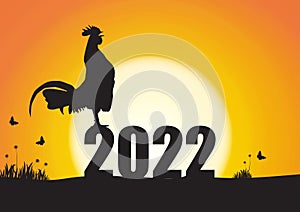 Silhouette of chicken crowing on number 2022 on sunrise background, new year celebration concept