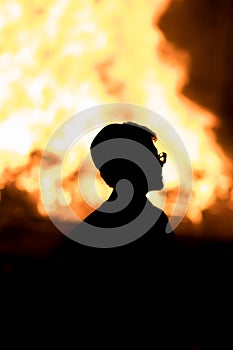 Silhouette of a child against a Lag Baomer bonfire