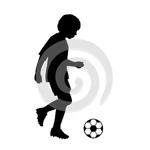 Silhouette child joggling with soccer ball