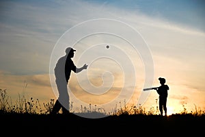 silhouette child with parent playing baseball concept