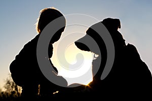 Silhouette of Child Playing with Dog